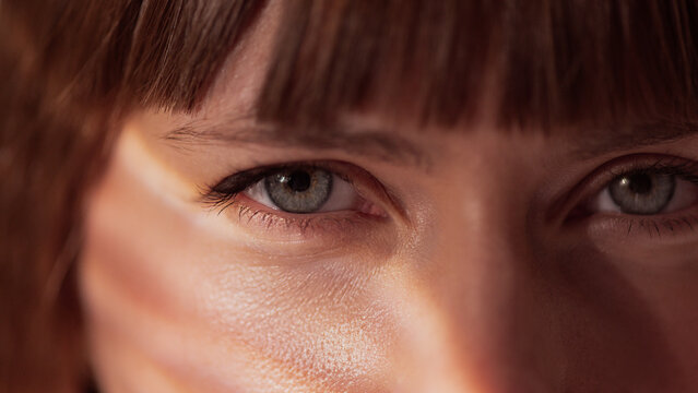 Woman soft portrait with warm light highlighting natural skin texture. Concept of dermatology, healthy lifestyle, self-care, beauty editorial, minimal aesthetic, and emotional softness.