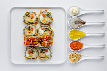 Baked sushi roll with salmon, tuna, shrimp, avocado and cream cheese