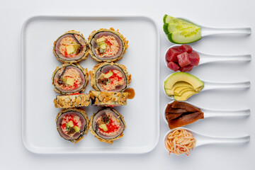 Baked sushi roll with salmon, tuna, shrimp, avocado and cream cheese