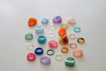 Collection of colorful plastic rings on white background. Selective focus.