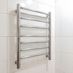 Chrome towel warmer on a tiled wall