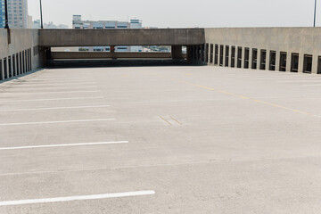 Fototapeta premium Open rooftop parking deck with empty spaces.