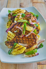grilled pork chops topped with pineapple chili pepper salsa