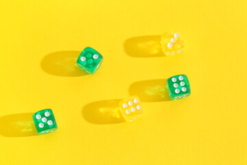 Different game dices on yellow background