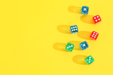 Different game dices on yellow background