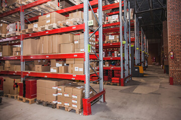 Storage area filled with stacked boxes and organized shelves in a warehouse facility
