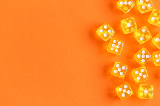 Yellow game dices on orange background