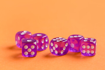 Purple game dices on orange background