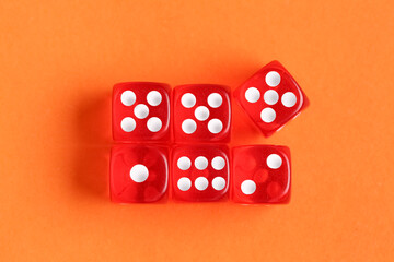 Red game dices on orange background