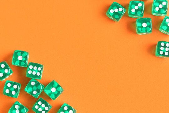 Green game dices on orange background