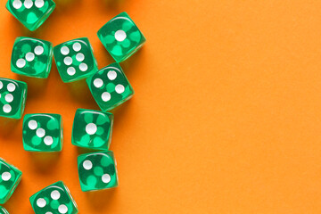 Green game dices on orange background