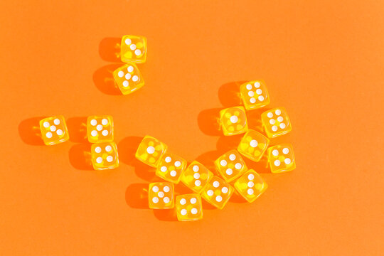 Yellow game dices on orange background