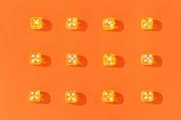 Yellow game dices on orange background