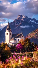 Church nestled in autumnal valley with mountains