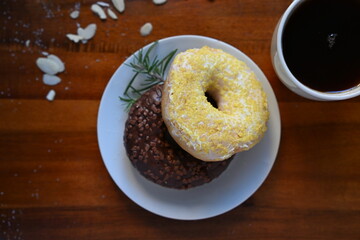 A top view of two exquisite donuts, one chocolate and one lemon. Suitable for a bakery menu or graphic design.