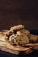 Freshly Baked Oatmeal Cookies on Wooden Serving Board Background