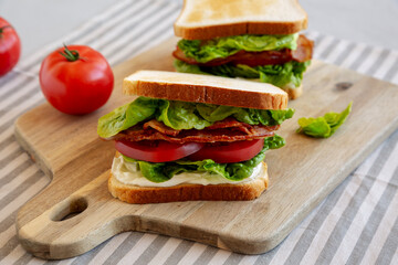 Homemade BLT (Bacon Lettuce Tomato) Sandwich with Mayo, side view.
