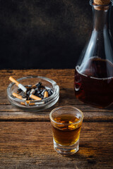 Dark Mood Still Life with Whiskey, Cigarettes, and Wooden Table