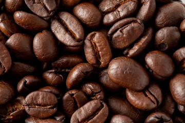 Close-Up View of Freshly Roasted Dark Coffee Beans on Surface