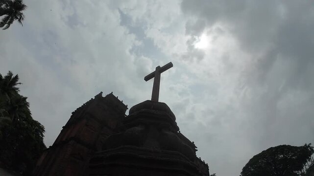 The Basilica of Bom Jesus: A Solemn Baroque Silhouette Against a Tempestuous Evening Sky, Embodying the Enduring Cross and the Dark Mystique of Old Goa, India