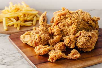 Crispy Fried Chicken with Golden French Fries on Wooden Serving Board