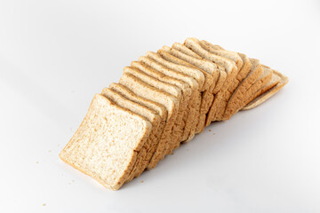Freshly Sliced Whole Wheat Bread Arranged on White Surface