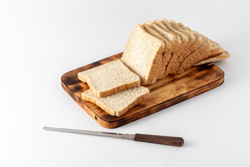 Freshly Sliced Bread on Wooden Cutting Board with Knife