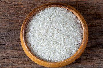 Close-Up of White Rice in Wooden Bowl on Rustic Wooden Surface