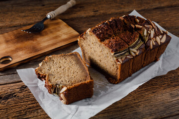 Fresh Homemade Banana Bread with Almonds on Wooden Table