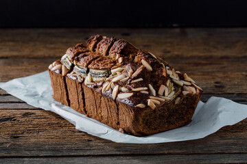 Deliciously Baked Zucchini Bread with Almonds on Wooden Surface