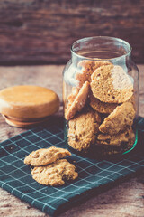 Freshly Baked Cookies in Glass Jar on Vintage Wooden Background