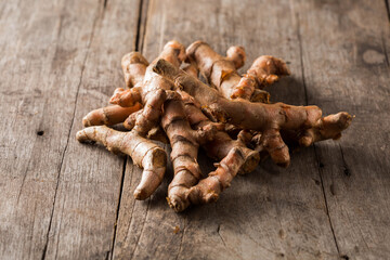 Fresh Raw Turmeric Roots on Rustic Wooden Surface Background