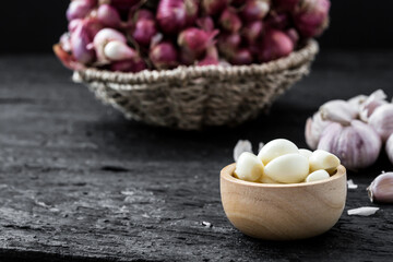 Fresh Garlic and Shallots in Wooden Bowl on Dark Background
