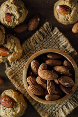 Fresh Baked Cookies with Almonds and Bowl of Almonds on Rustic Cloth