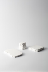Three Textured White Blocks of Various Shapes on Minimal Background