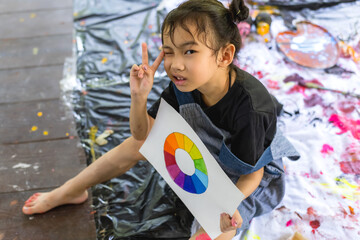 Portrait cute Asian artist girl having fun with watercolor in art class