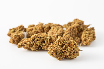 Close-Up of Dried Brown Cannabis Buds on White Background