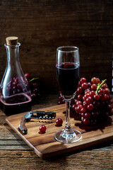 Elegant Glass of Red Wine with Grapes and Corkscrew on Wooden Table