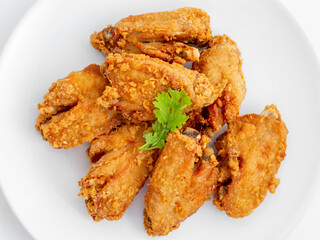 Crispy Golden Fried Chicken Wings on White Plate for Delicious Meal