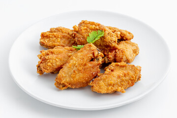 Crispy Fried Chicken Wings on White Plate Garnished with Herb