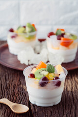 Fresh Fruit Dessert in Clear Cups with Yogurt and Mint Leaves