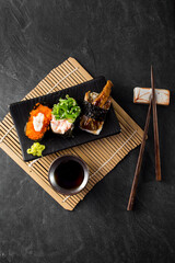 Delicious Sushi Platter with Various Toppings and Soy Sauce
