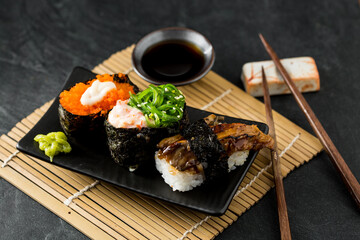 Assorted Sushi Rolls with Fresh Ingredients and Soy Sauce Presentation