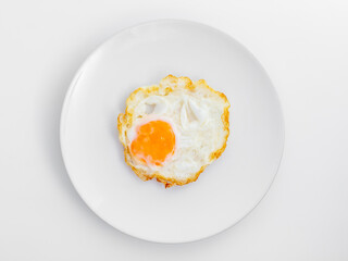 Fried Egg on White Plate Perfect for Breakfast or Culinary Use