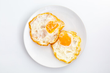 Fried eggs on a plate with a light background and simple presentation
