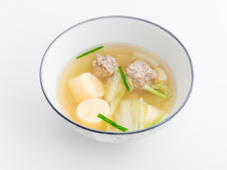 Delicious bowl of clear soup with meatballs and soft tofu