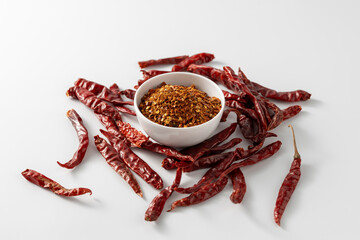 Red Chili Powder and Dried Peppers on White Background
