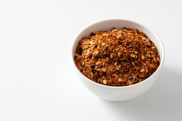 Spicy Chili Flakes in a Simple White Bowl on a Clean Surface