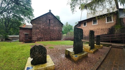  Exterior view of the historic Chapel of St. Catherine, showcasing medieval architecture on a cloudy, rainy day