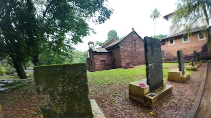  Exterior view of the historic Chapel of St. Catherine, showcasing medieval architecture on a cloudy, rainy day